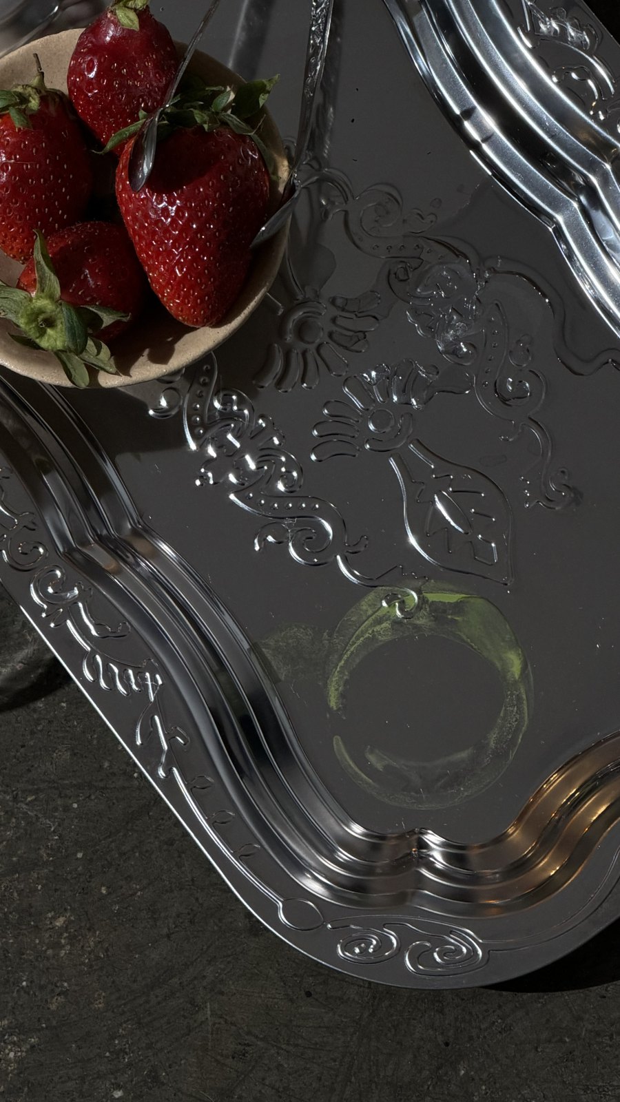 Fresh strawberries and matcha on a silver tray